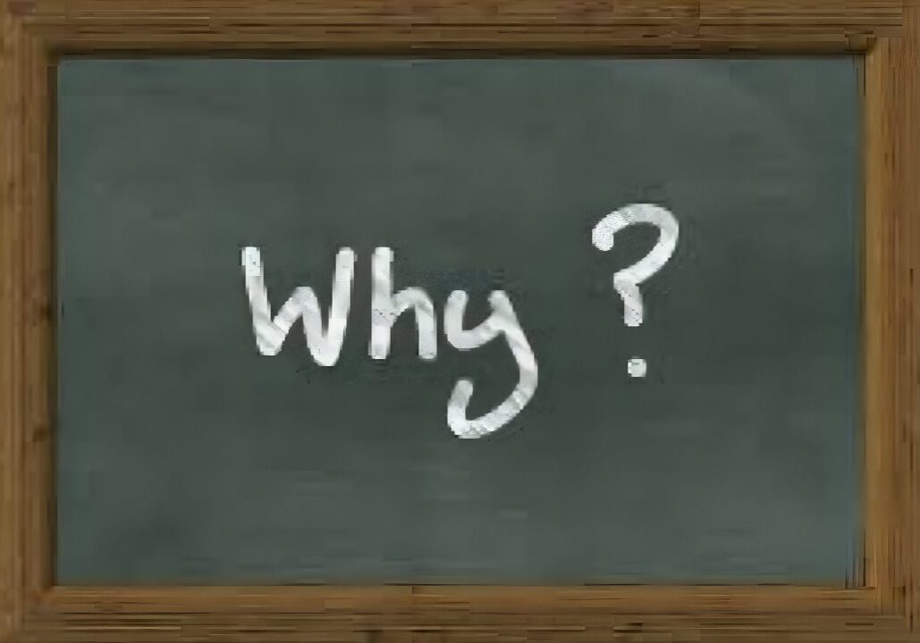 Blackboard with the word 'Why?' written in white chalk.
